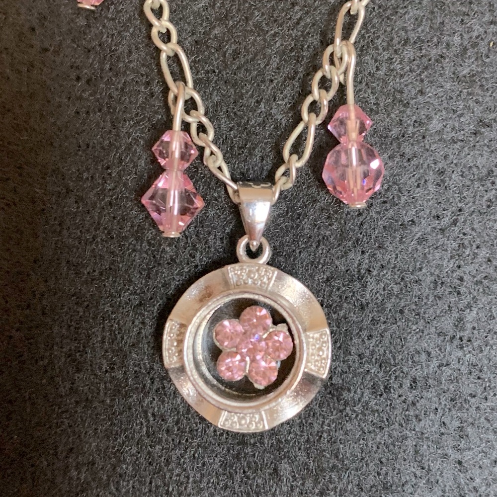 Young girl’s necklace with beautiful pink toned spinner, and magnetic clasp